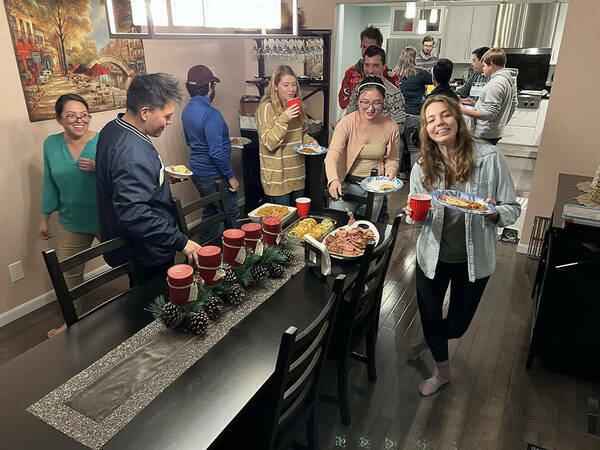 Picture of lab members getting food in our Winter party 2021.