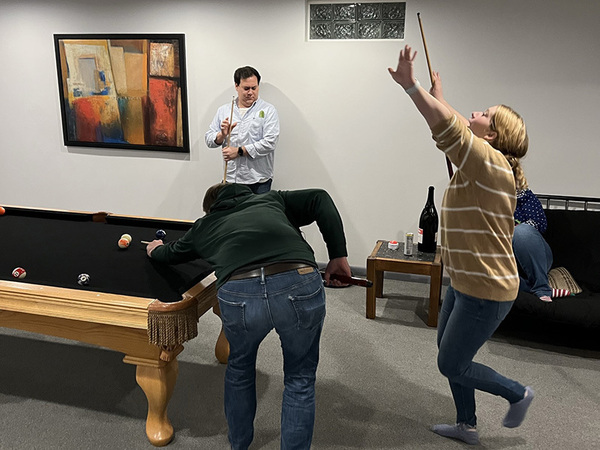 A picture of lab members playing pool in our Winter party 2022.