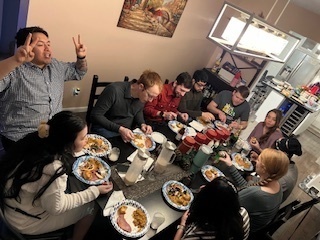 A picture of the lab groups digging in on the Winter party food of 2023!